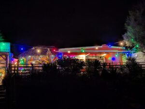 Am Strand von Marseillan Plage - bunt beleuchtete Strandbar am Abend